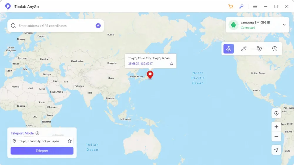 The iToolab AnyGo desktop app showing a world map with a search bar and a red teleport pin dropped on downtown Tokyo, with a connected Android phone icon in the top corner.