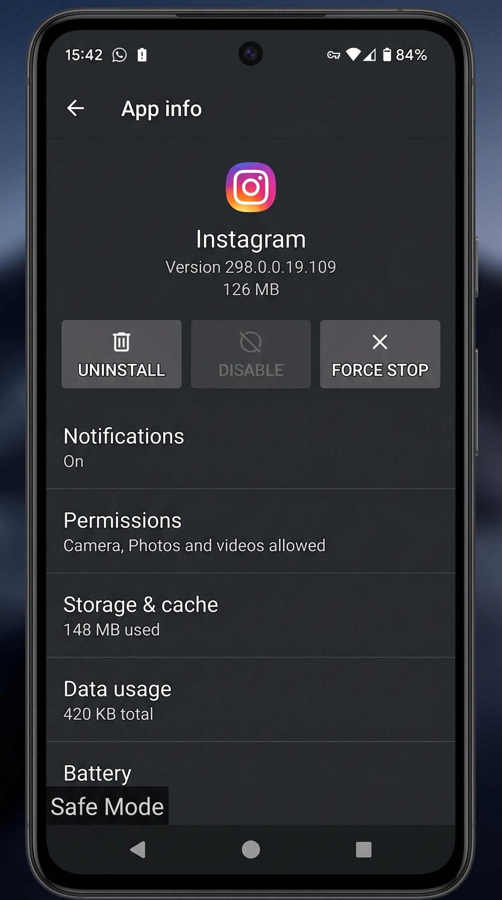 Android phone booted into Safe Mode with the "Safe Mode" label in the bottom-left corner and an app-info screen showing the Uninstall button.
