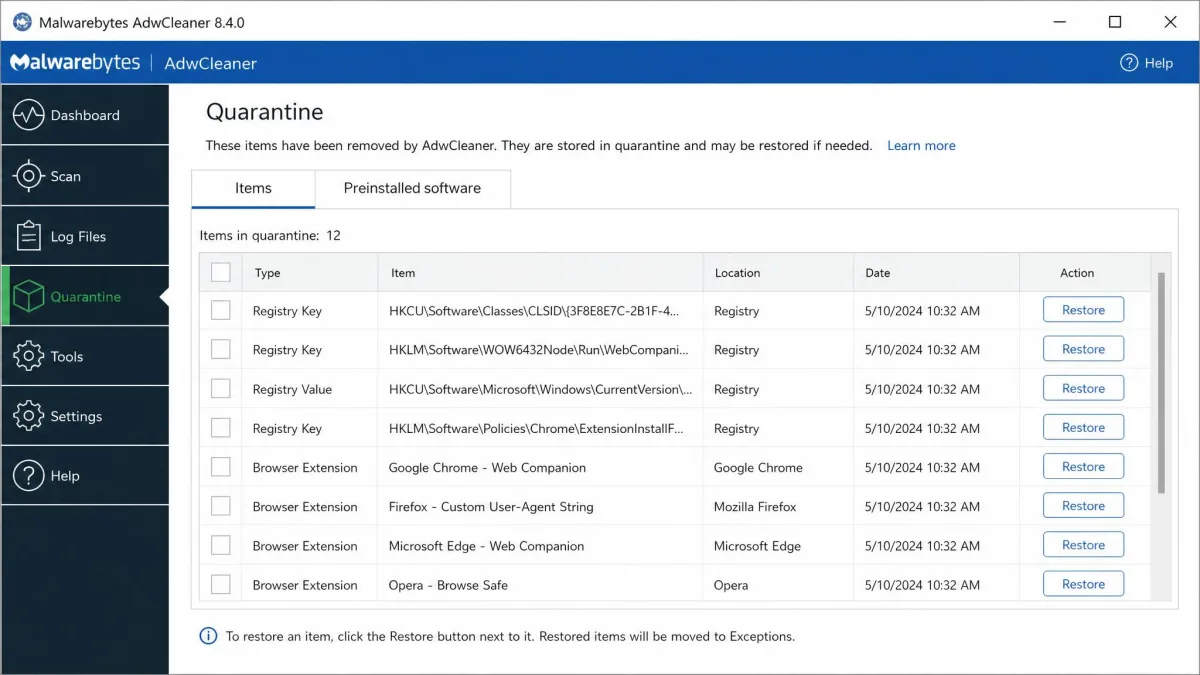 AdwCleaner's quarantine screen listing removed registry keys and browser extensions with a Restore button beside each entry.