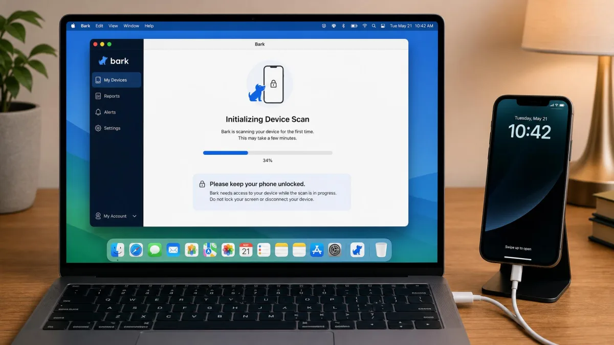 A laptop running the Bark desktop app with an iPhone connected by cable, the screen showing a progress bar for the initial device scan and an on-screen instruction to keep the phone unlocked.