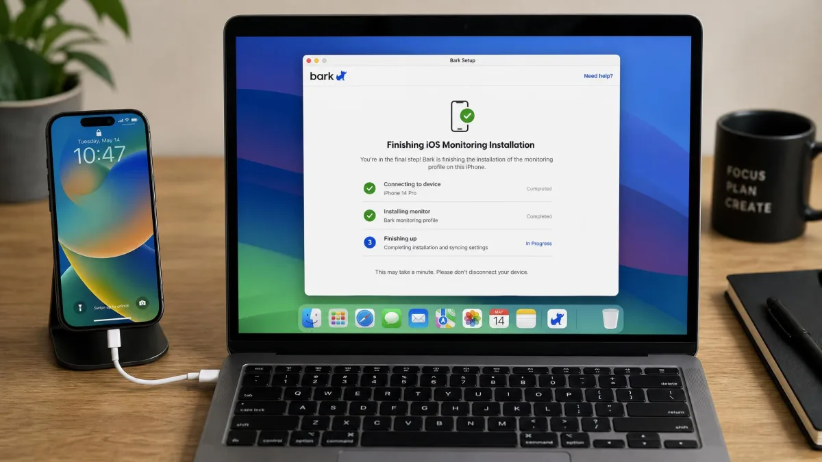 An iPhone connected by cable to a laptop running the Bark desktop setup app, with the on-screen progress step for finishing iOS monitoring installation visible.