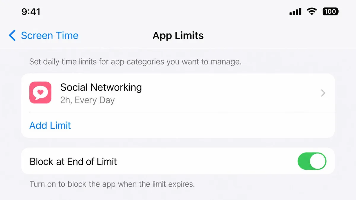 An iPhone Settings screen showing Screen Time App Limits with the Block at End of Limit toggle switched on and a two hour social networking limit listed above it.