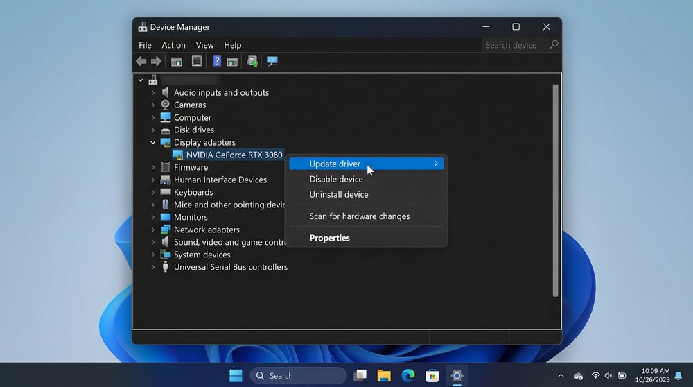 Windows 11 Device Manager with a graphics adapter right-clicked and the Update driver option highlighted.