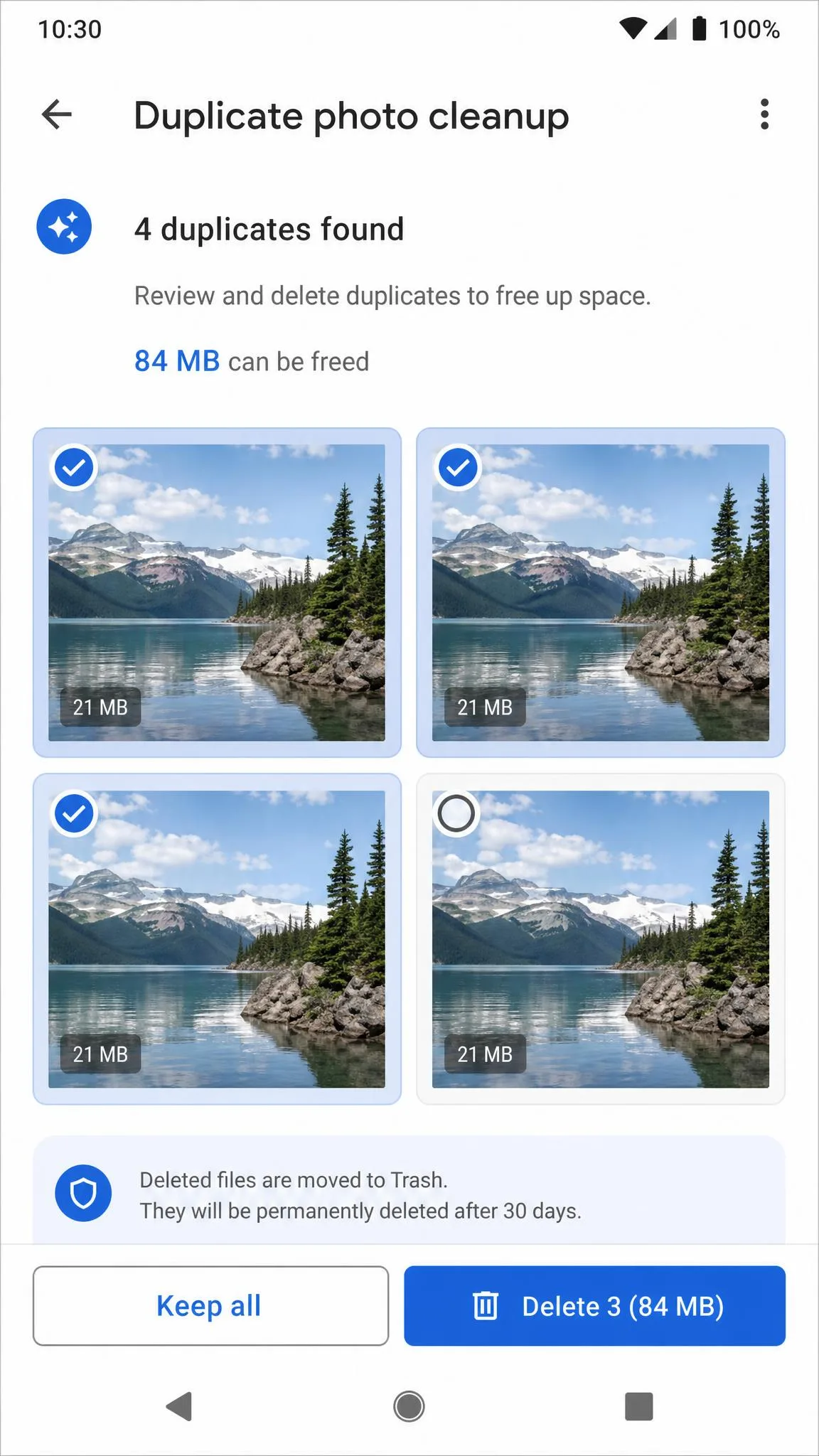 Duplicate photo cleanup screen on an Android phone showing four near-identical landscape shots grouped together, with three selected for deletion and a total of 84 MB to be freed.