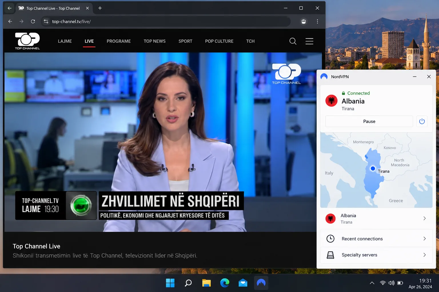 A browser window playing an Albanian TV channel's live stream while a VPN app in the corner shows a connection to an Albanian server in Tirana.