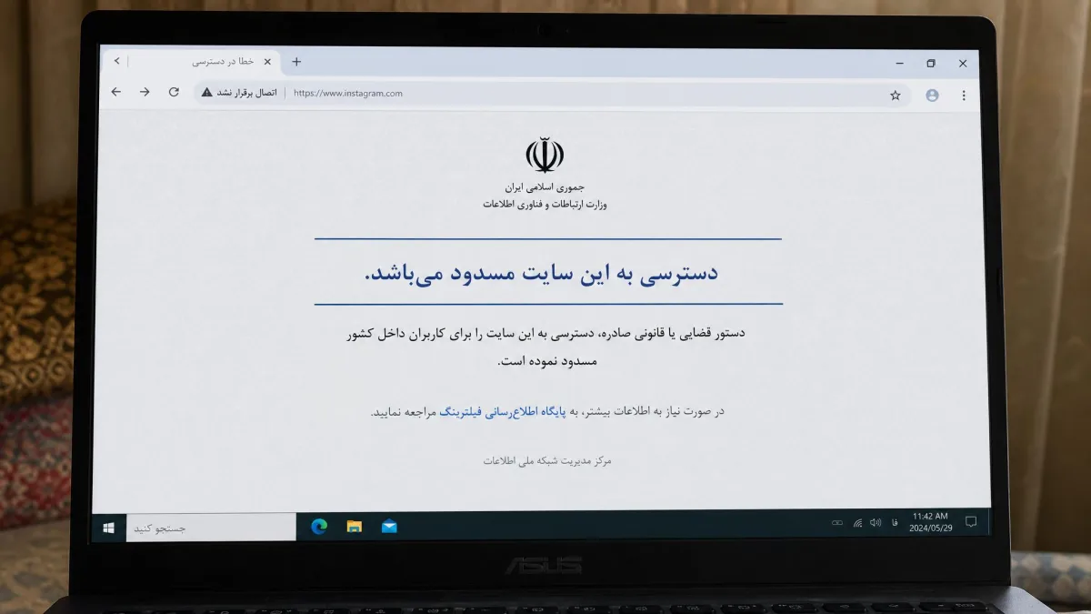 A laptop browser in Iran displaying a government block page in Persian where a social media site should be, with the address bar showing a failed connection.