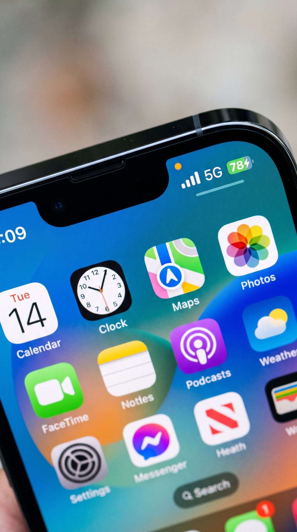 Close-up of an iPhone status bar with the orange microphone-active dot lit while the home screen is showing and no obvious app is open.