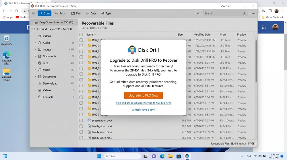 Disk Drill on Windows 11 displaying an upgrade-to-Pro prompt after a completed scan, with recoverable files visible but greyed out behind the paywall.