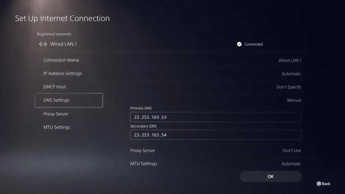 A PlayStation 5 network settings screen with Manual DNS selected and the two ExpressVPN MediaStreamer addresses entered as primary and secondary DNS.