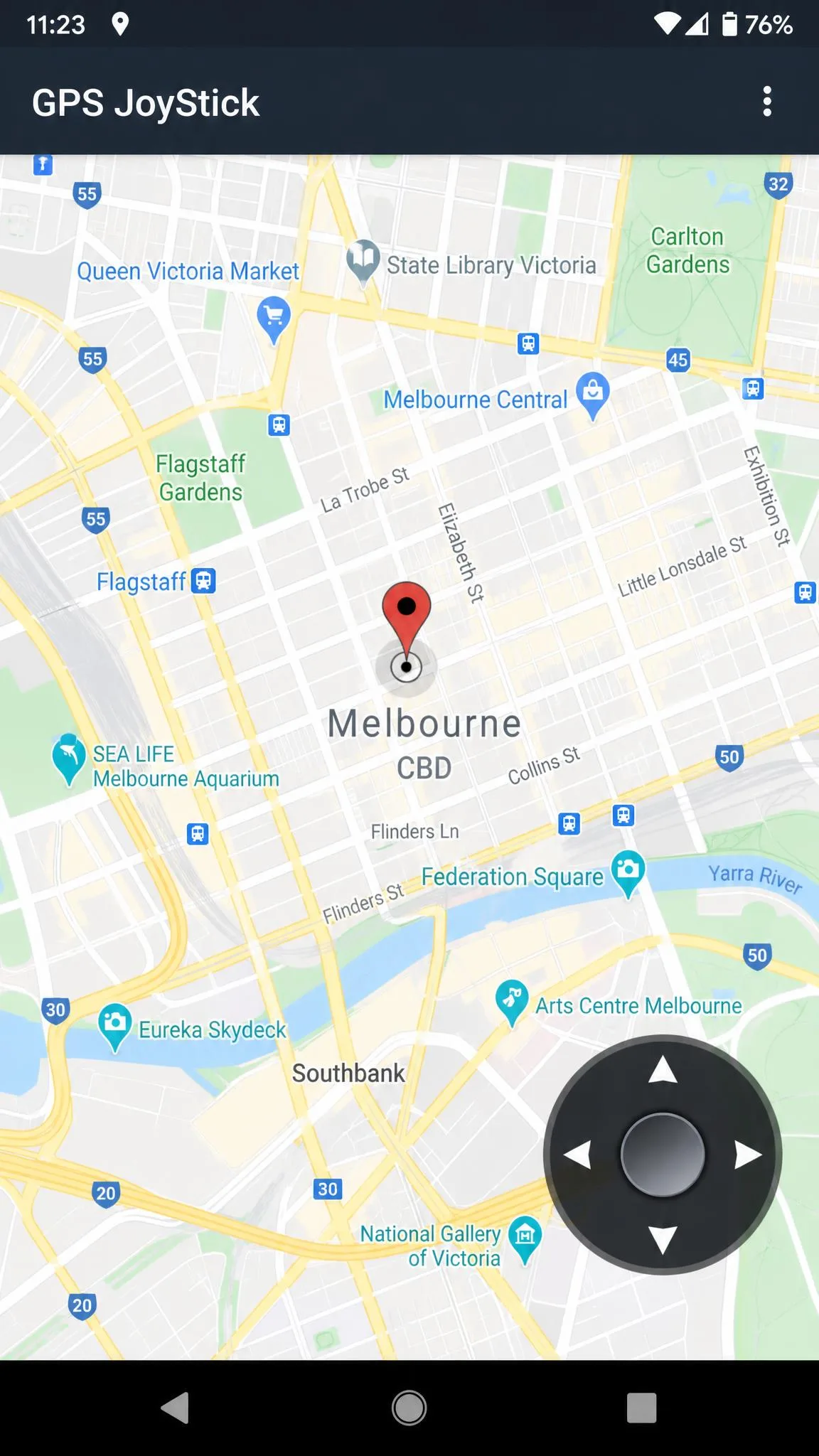 The GPS JoyStick overlay control sitting on top of a city map on an Android phone, with the joystick pad in the lower right corner and a teleport pin in the centre.