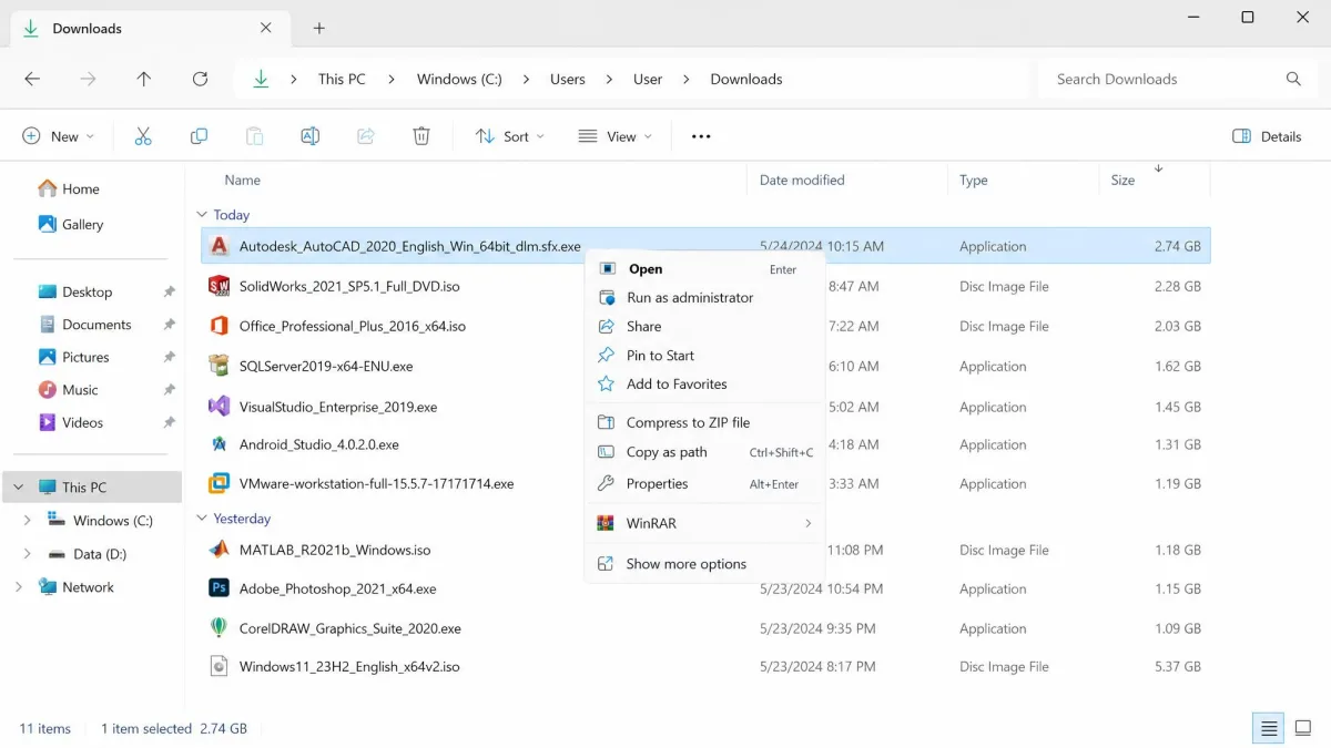 File Explorer Downloads folder in Details view sorted by size, showing several old application installer files over 1 GB each and a right-click menu open on the largest one.