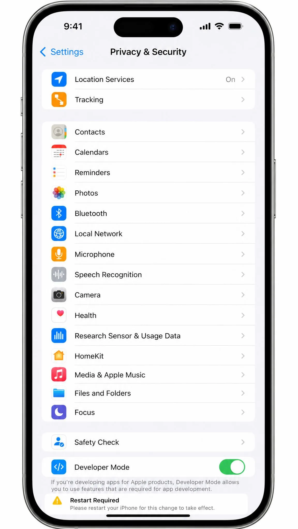 An iPhone Settings screen open on Privacy and Security with the Developer Mode toggle switched on and a restart-required warning below it.