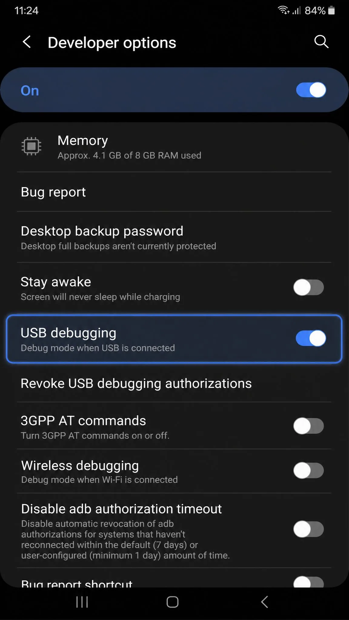 An Android phone's Developer options screen with the USB debugging toggle switched on and highlighted, taken during setup for a desktop location changer.