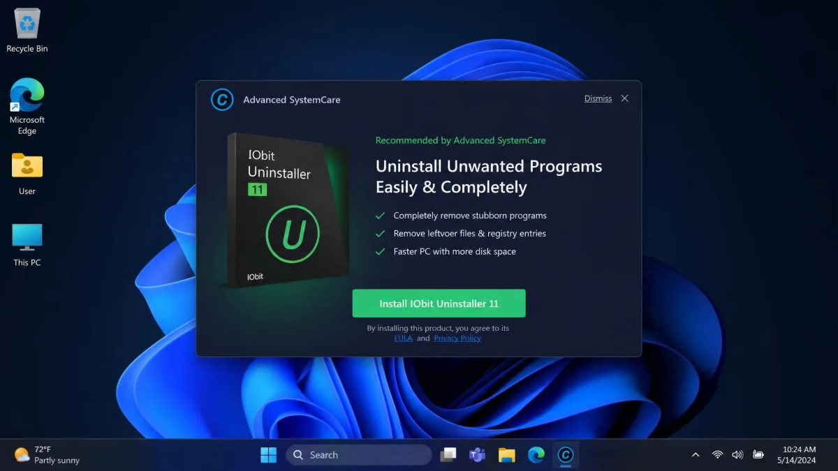 An Advanced SystemCare promotional pop-up over the Windows 11 desktop, offering another IObit utility with a green install button and a small dismiss link in the corner.