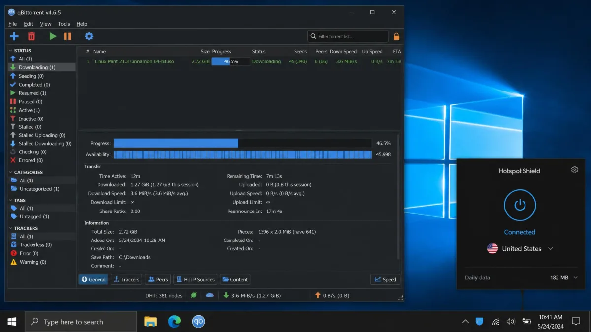 A torrent client downloading a file at a steady speed while Hotspot Shield shows an active connection to a US server in the system tray.
