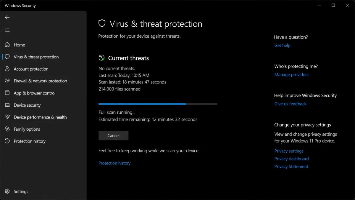 The Windows Security virus and threat protection screen mid full scan, showing 214,000 files scanned and no current threats found.
