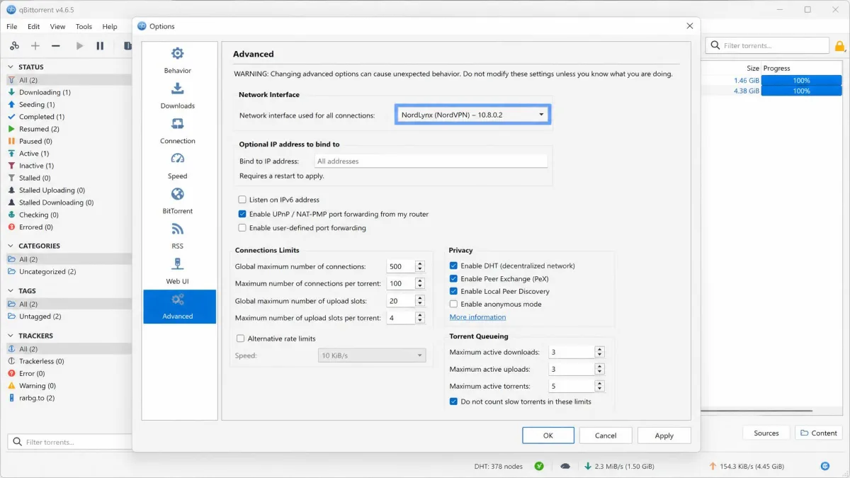 qBittorrent Advanced options pane open, with the Network Interface dropdown highlighted and set to a VPN adapter instead of the default Any interface.