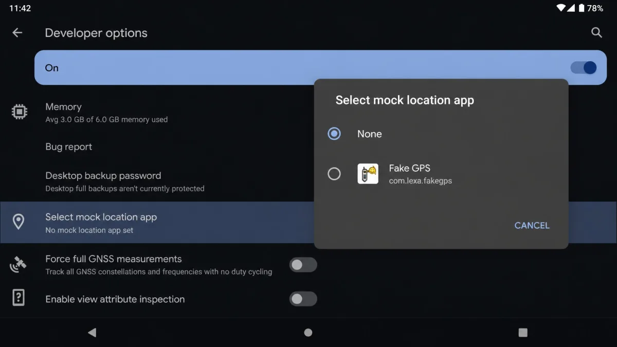 The Android Developer options screen with the Select mock location app entry highlighted and a dialog open showing None alongside an installed fake GPS app.