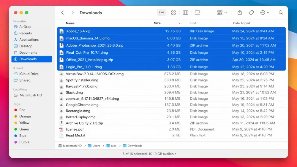 A macOS Finder window showing the Downloads folder sorted by file size in list view, with several large disk image and zip files highlighted for deletion.