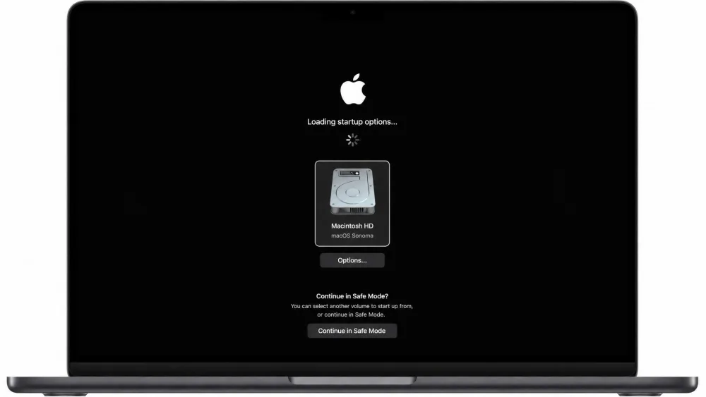 An Apple Silicon Mac showing the Loading startup options screen with a startup volume selected and the Continue in Safe Mode prompt visible.
