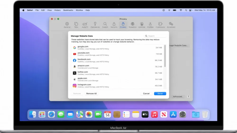 A MacBook screen showing Safari's Privacy settings open with the Manage Website Data window in front, ready to clear cached browser data.