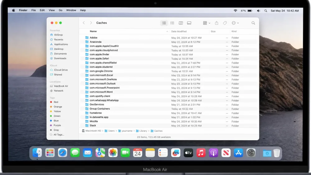 A Finder window on a MacBook showing the contents of the user Library Caches folder, with multiple app cache subfolders listed.