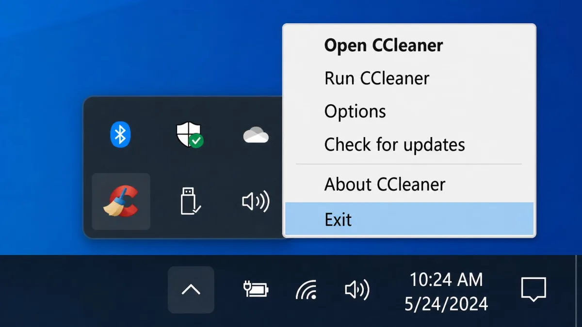 Close-up of the Windows notification area showing the CCleaner tray icon and its right-click menu with the Exit option highlighted.