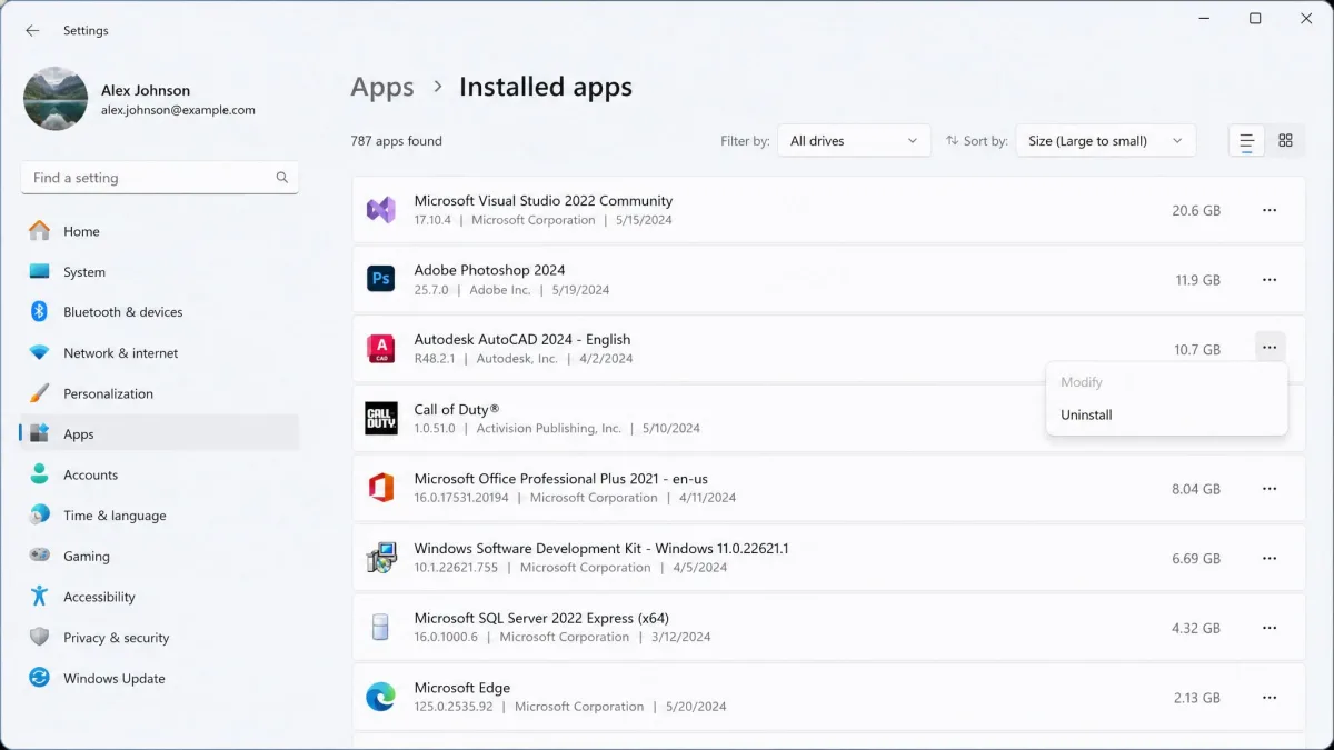 The Windows 11 Installed apps list sorted by size, with the largest entries at the top showing multi-gigabyte figures and a three-dot menu open on one row revealing the Uninstall option.