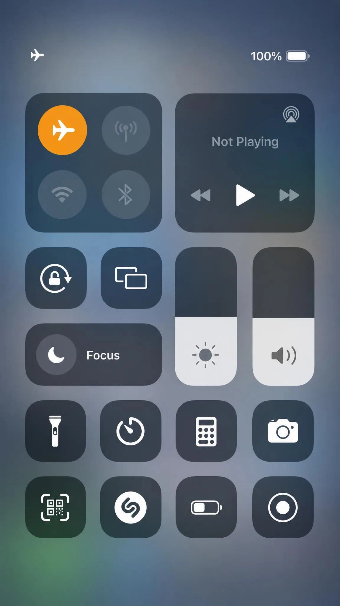 iPhone Control Centre with the aeroplane icon highlighted orange to show Airplane Mode is on, with the Wi-Fi and cellular icons dimmed beside it.