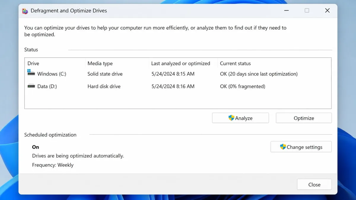 The Defragment and Optimize Drives window in Windows 11 showing one drive listed as a solid state drive and another as a hard disk drive, with the weekly schedule enabled.