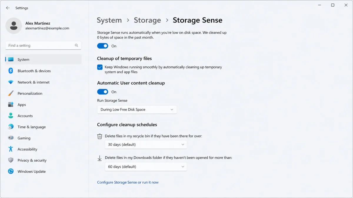 The Storage Sense settings page in Windows 11 Settings, with the main toggle switched on, the cleanup schedule dropdown set to During Low Free Disk Space, and the Recycle Bin and Downloads threshold options below.