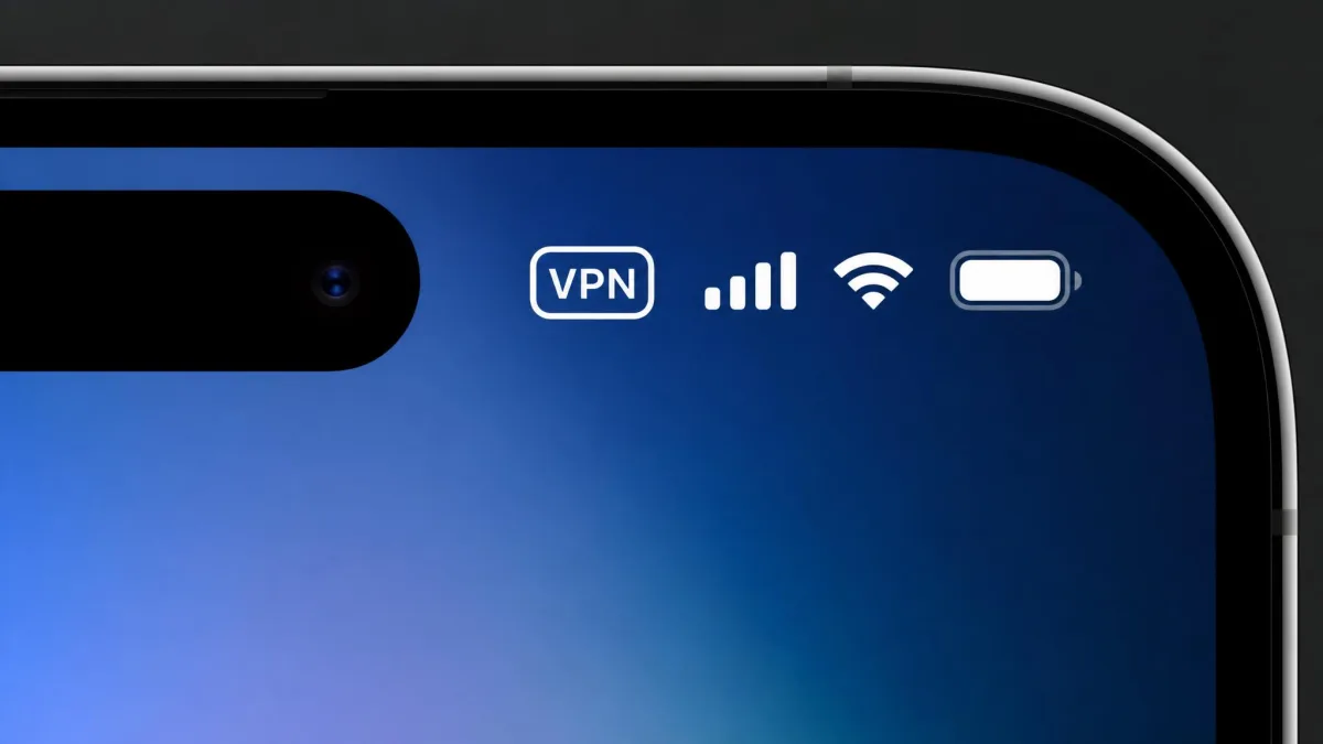 Close-up of an iPhone status bar showing the small VPN badge next to the Wi-Fi and battery icons, confirming an active VPN connection.