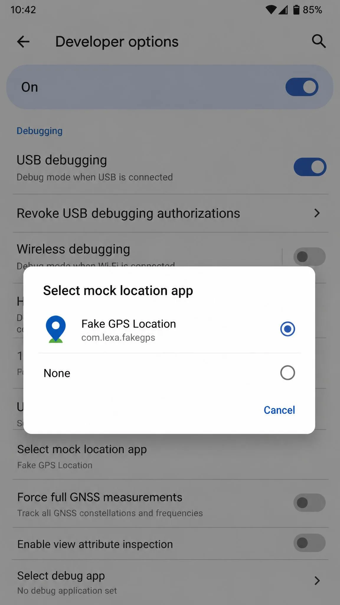 Android Developer options Debugging section with the Select mock location app dialog open, listing Fake GPS Location as a selectable provider.