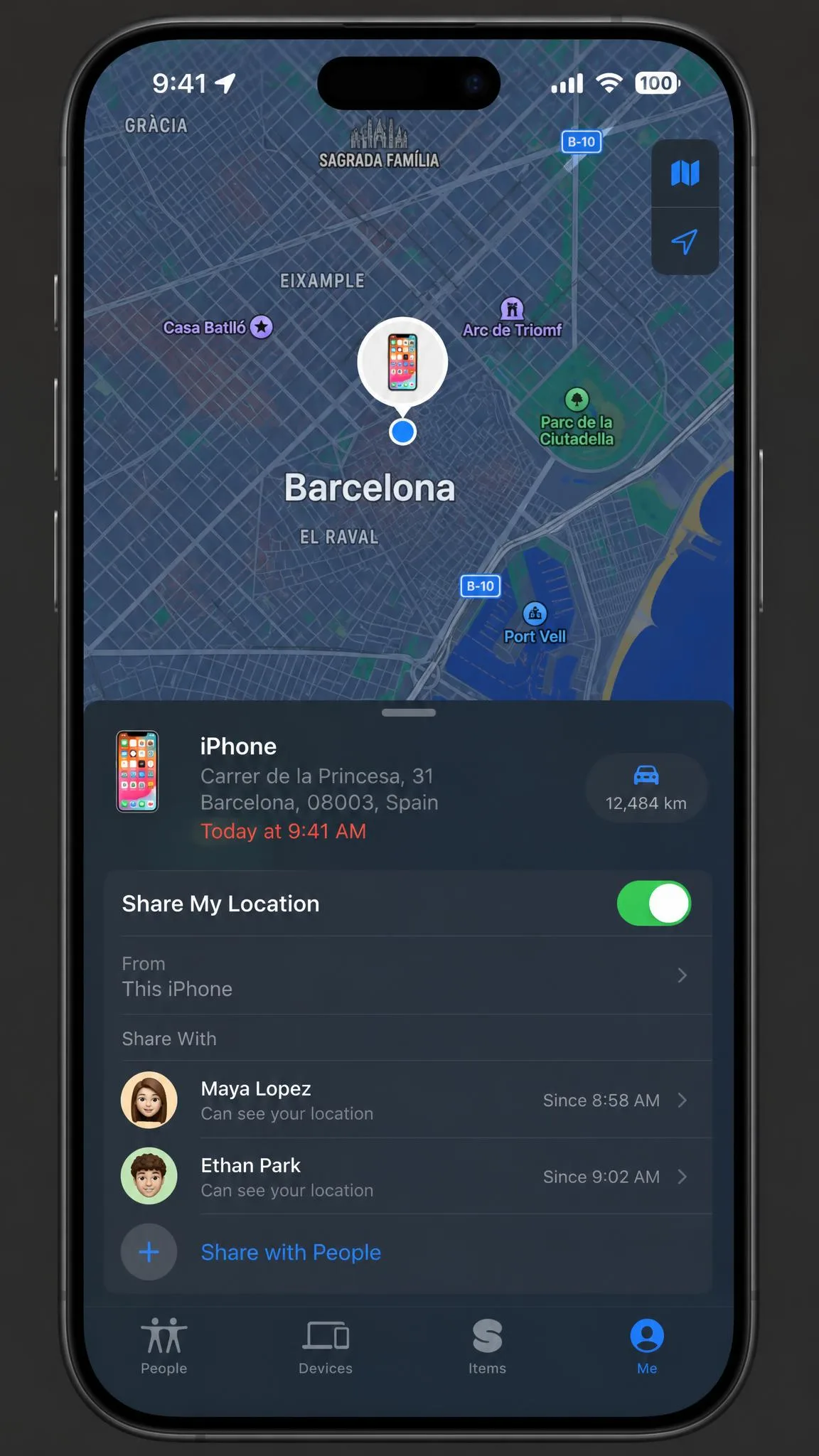 The Find My app on an iPhone displaying the device pinned in a foreign city while the user is somewhere else, with the location sharing panel open below the map.