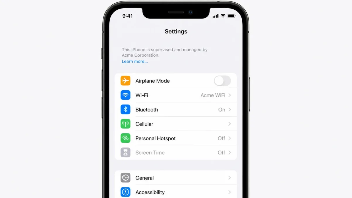 A Settings screen on a managed iPhone showing the grayed-out Screen Time option and the This iPhone is supervised message near the top of the list.