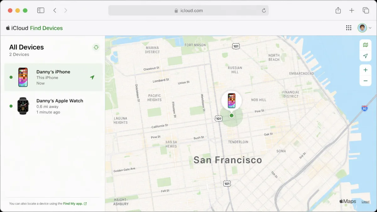 The Find Devices page on iCloud.com in a laptop browser showing an iPhone and an Apple Watch listed with one device selected and pinned on a city map.