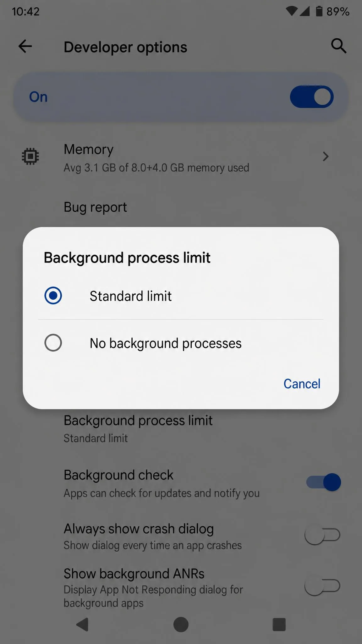 The Developer options screen on Android with the Background process limit menu open, showing Standard limit and No background processes.