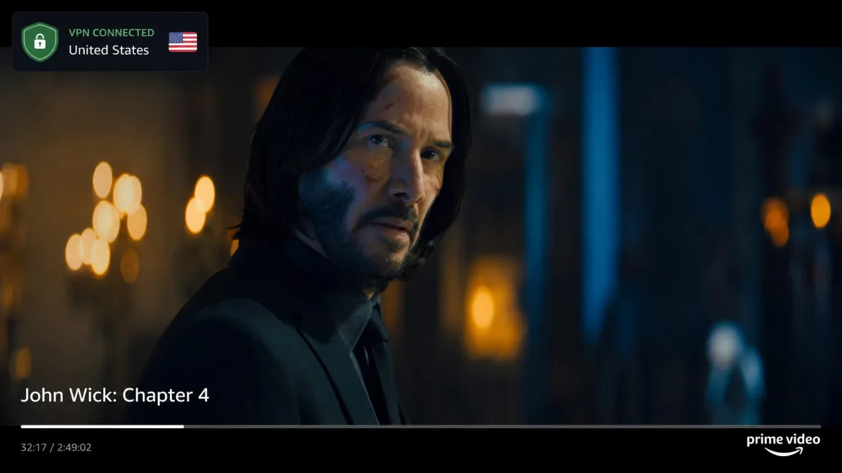 A film playing full screen in Prime Video with a small VPN status badge in the corner confirming an active connection to a US server.