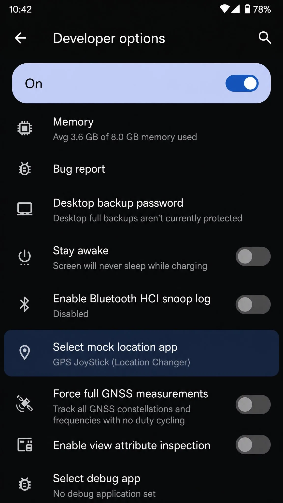 An Android phone settings screen showing Developer options open, with the Select mock location app entry highlighted and a location changer app selected.