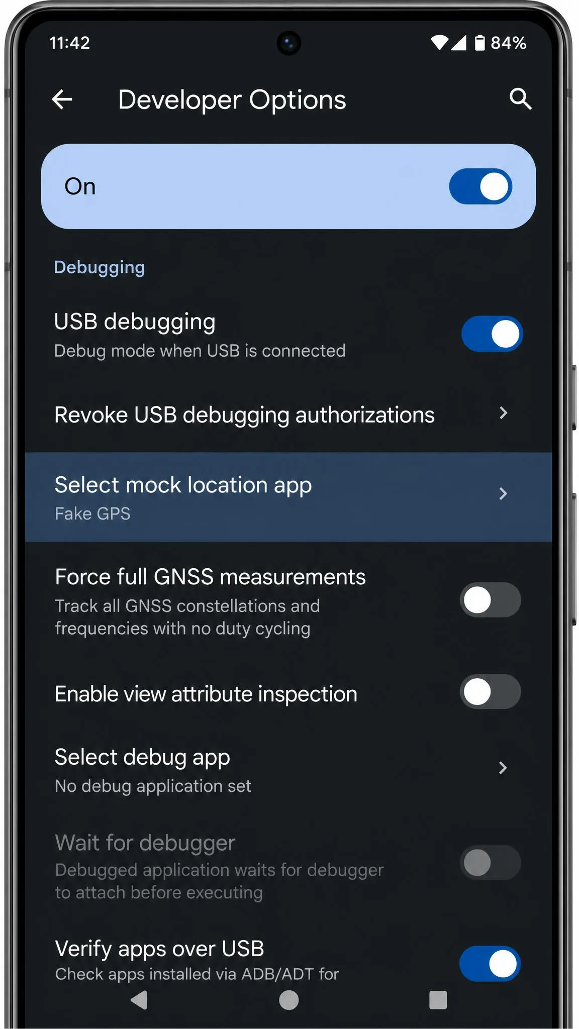 An Android phone's Developer Options screen with USB debugging switched on and the select mock location app entry highlighted below it.