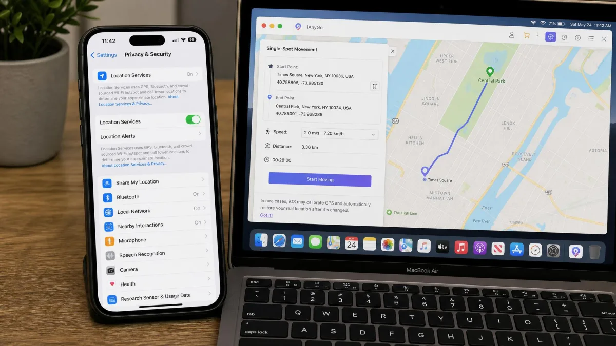 iPhone Settings screen open on Privacy and Security with Location Services toggled on, shown on a phone resting beside a laptop running a location changer app.