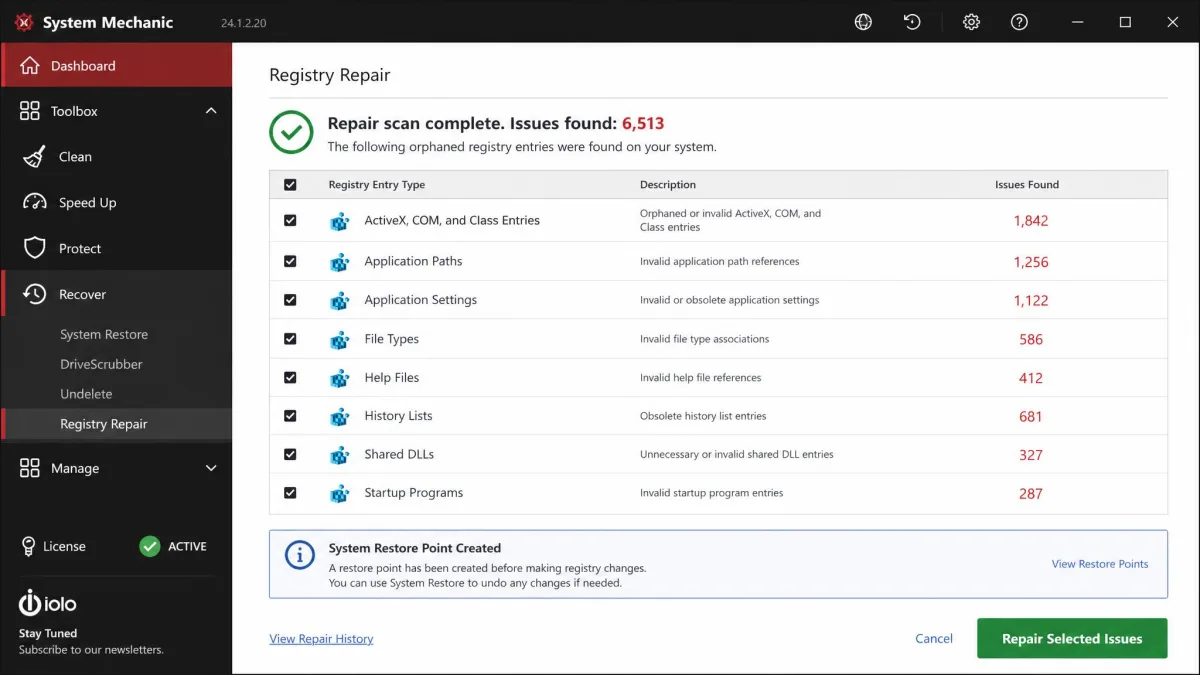 System Mechanic registry repair results listing thousands of orphaned registry entries grouped by type, with a repair button and a restore point notice.