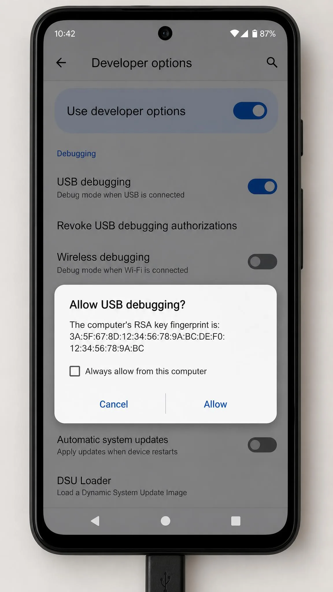 An Android handset showing the Developer options screen with the USB debugging toggle switched on and a trust dialogue waiting for approval.