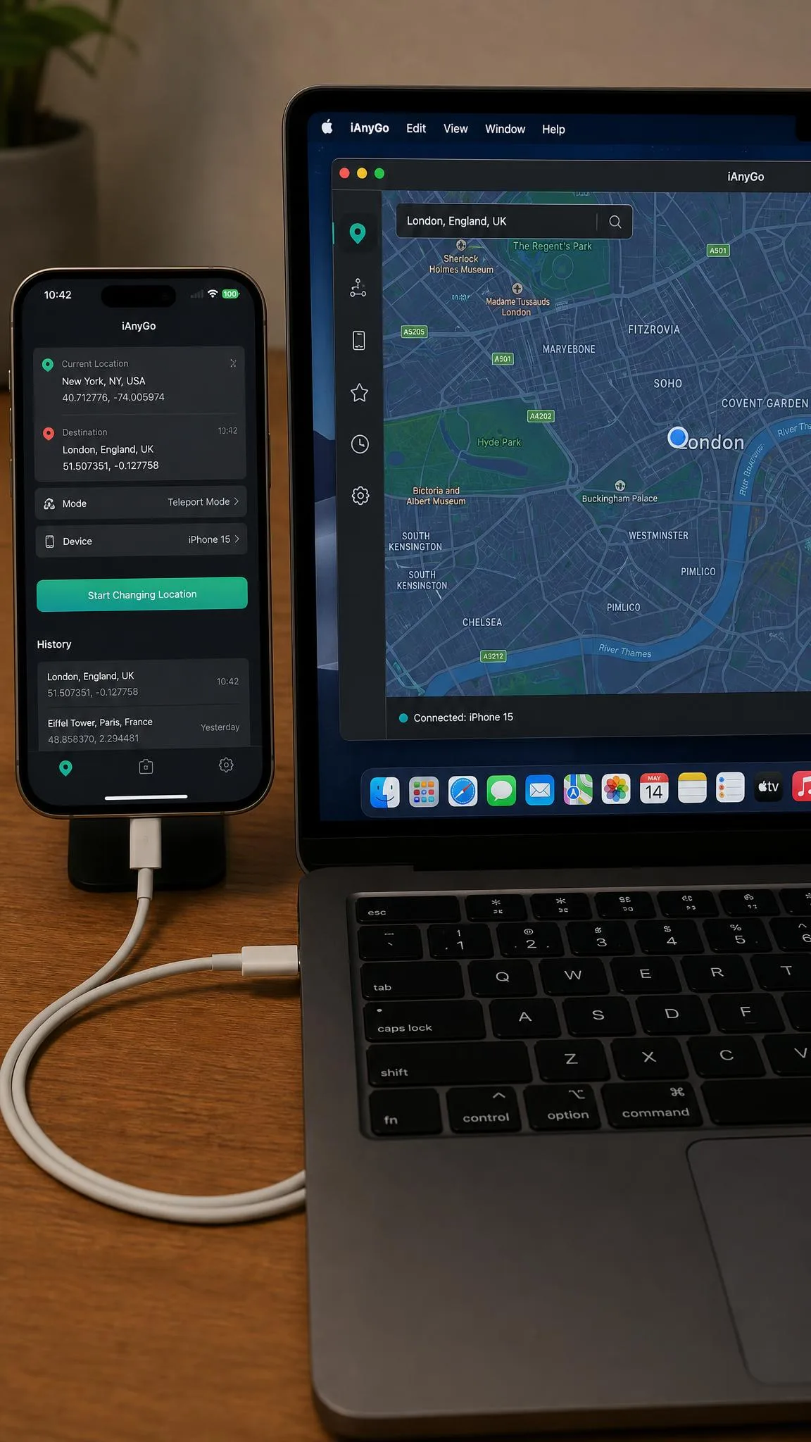 An iPhone 15 connected to a laptop by USB during our location changer test, with the spoofing app open on screen.