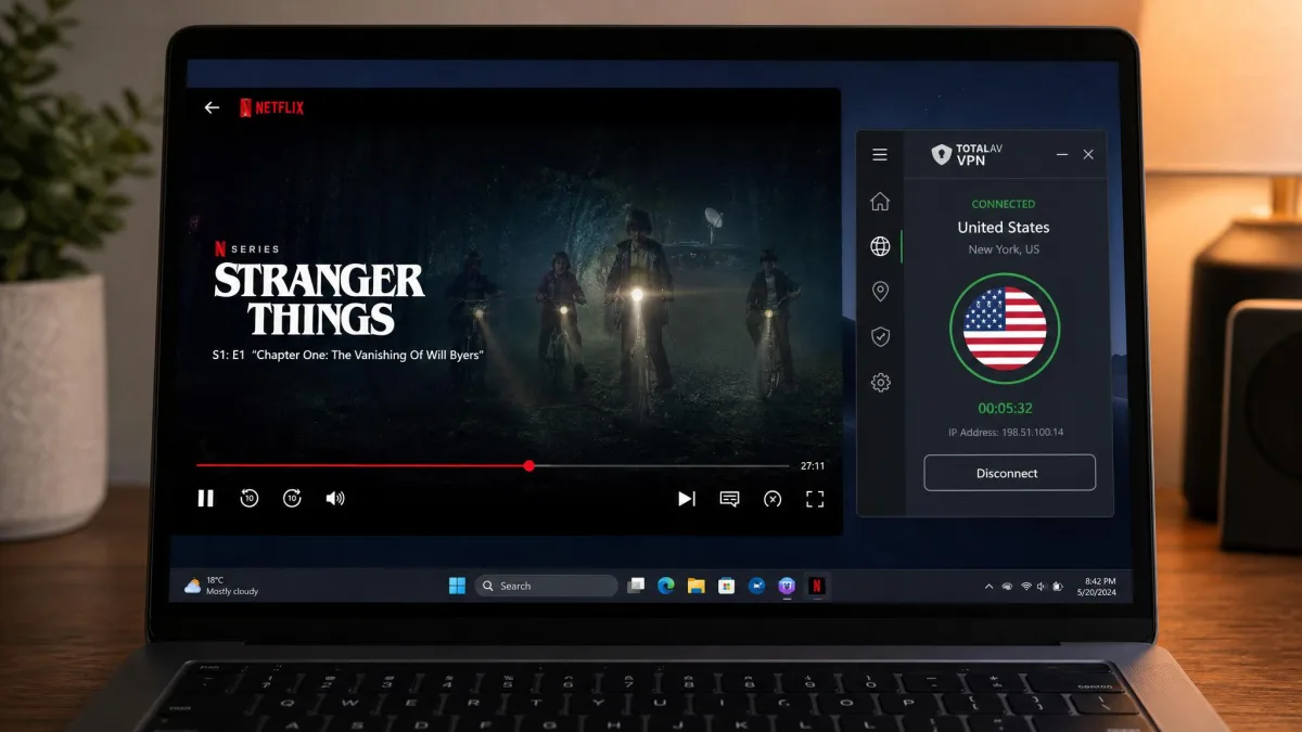 Laptop screen showing a Netflix show playing successfully while the TotalAV VPN app sits connected to a US server in a smaller window beside it.
