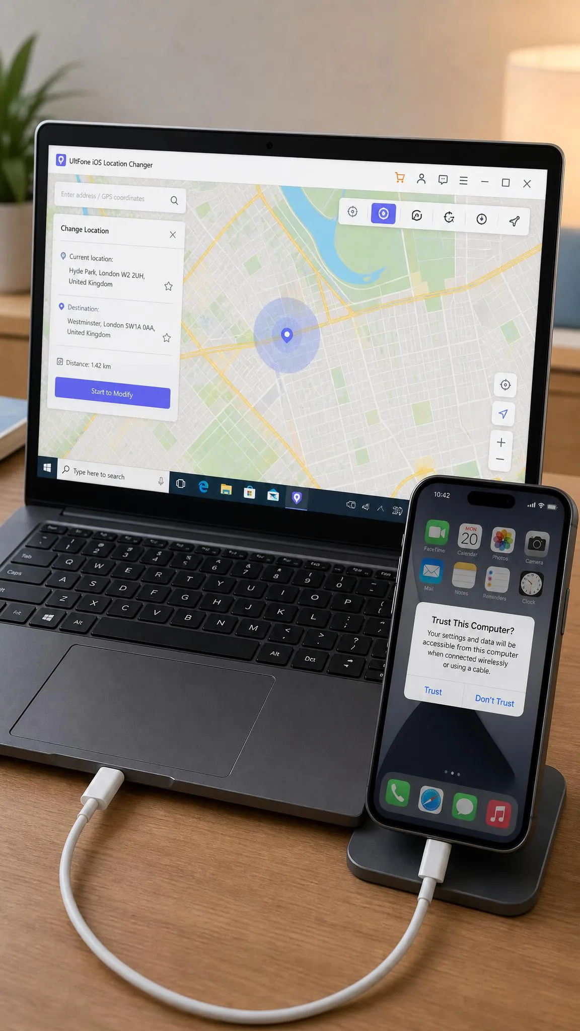 An iPhone 15 connected by USB cable to a Windows laptop, with the UltFone map open on the laptop screen and the phone showing the Trust This Computer prompt.