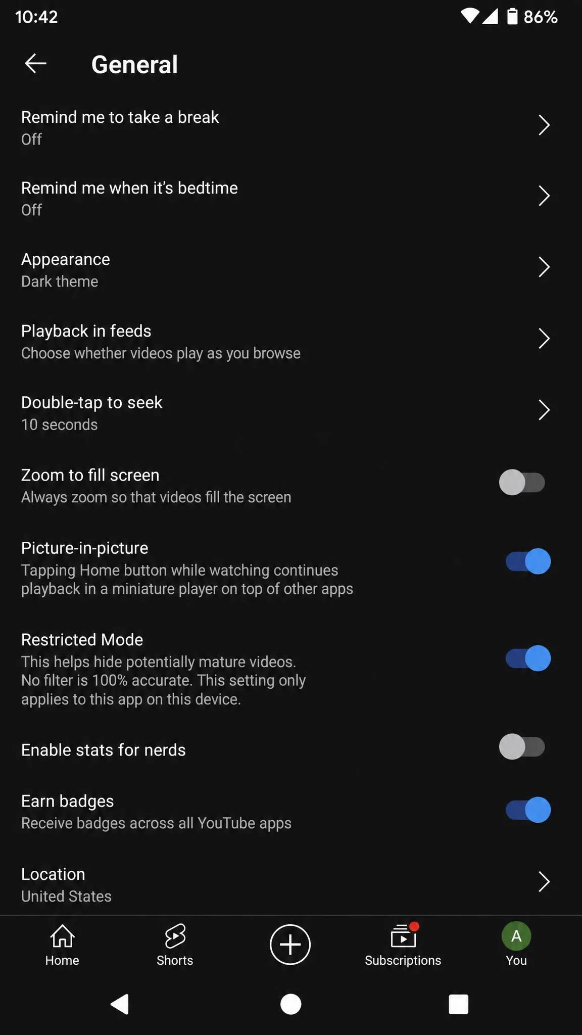 The YouTube mobile app General settings screen on an Android phone showing the Restricted Mode row switched on.