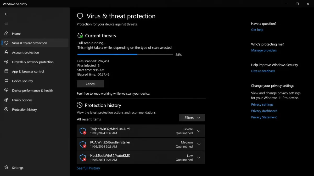 Windows Security virus and threat protection screen mid full scan, showing the number of files scanned, elapsed time, and a list of quarantined threats below.