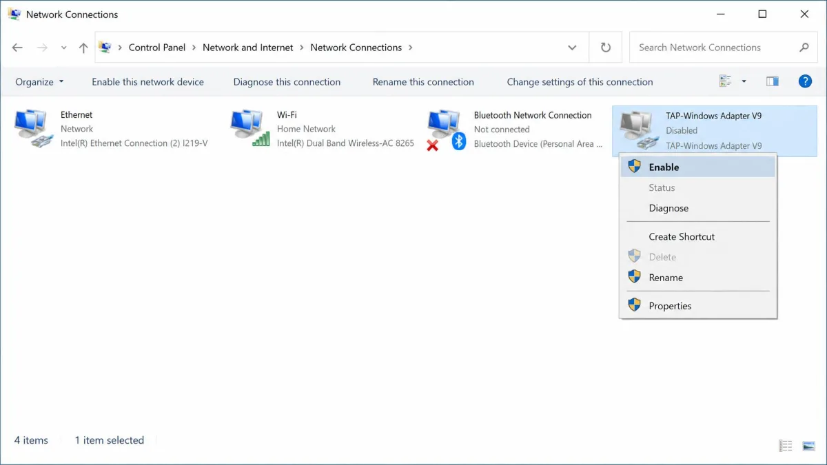 Windows Network Connections window showing the TAP-Windows Adapter V9 with a right-click menu open on the Enable option after the adapter was found disabled.